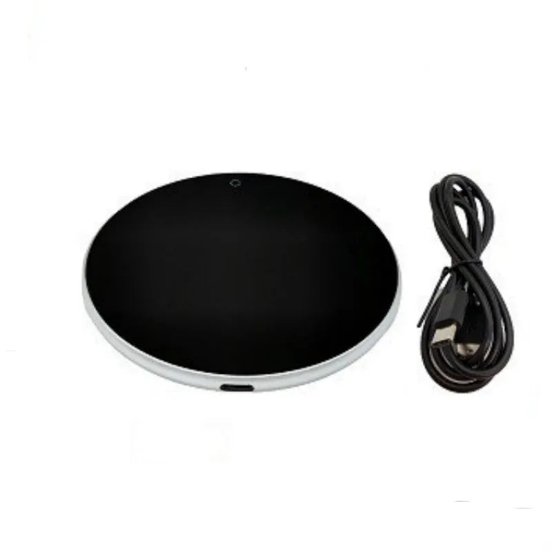 Black USB heating coaster with a mug on its tempered glass surface, showing a red LED indicator light.