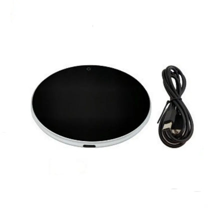 Black USB heating coaster with a mug on its tempered glass surface, showing a red LED indicator light.