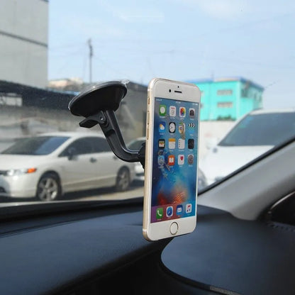 Black magnetic car phone holder with rotating head shown mounted on dashboard