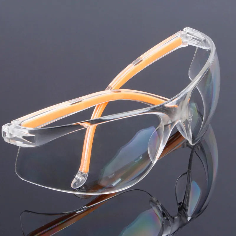 Transparent polycarbonate safety goggles with yellow frame for lab and welding protection.