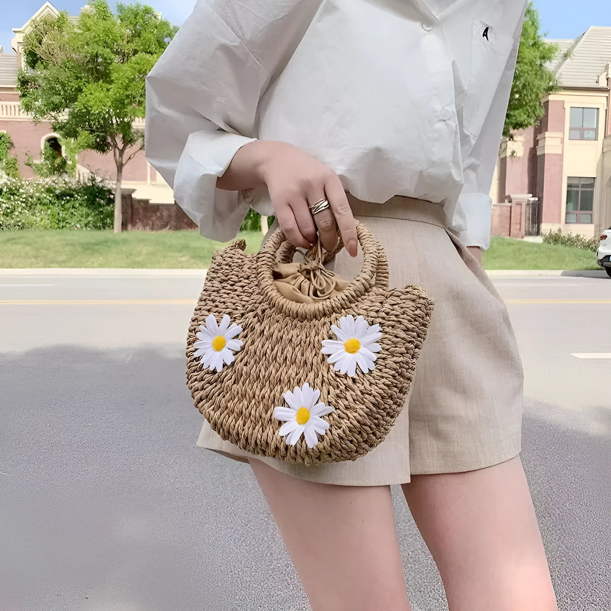 Women's light brown straw woven crossbody bag with daisy flower design showing 25x20x8 cm dimensions