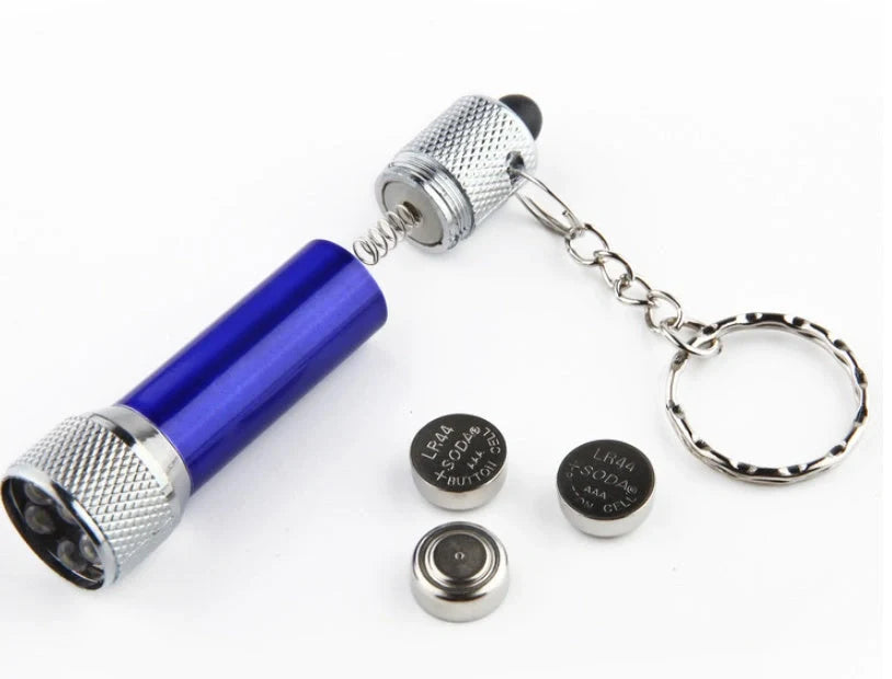 Compact aluminium LED keychain torch in four colours: white, black, red, and blue.