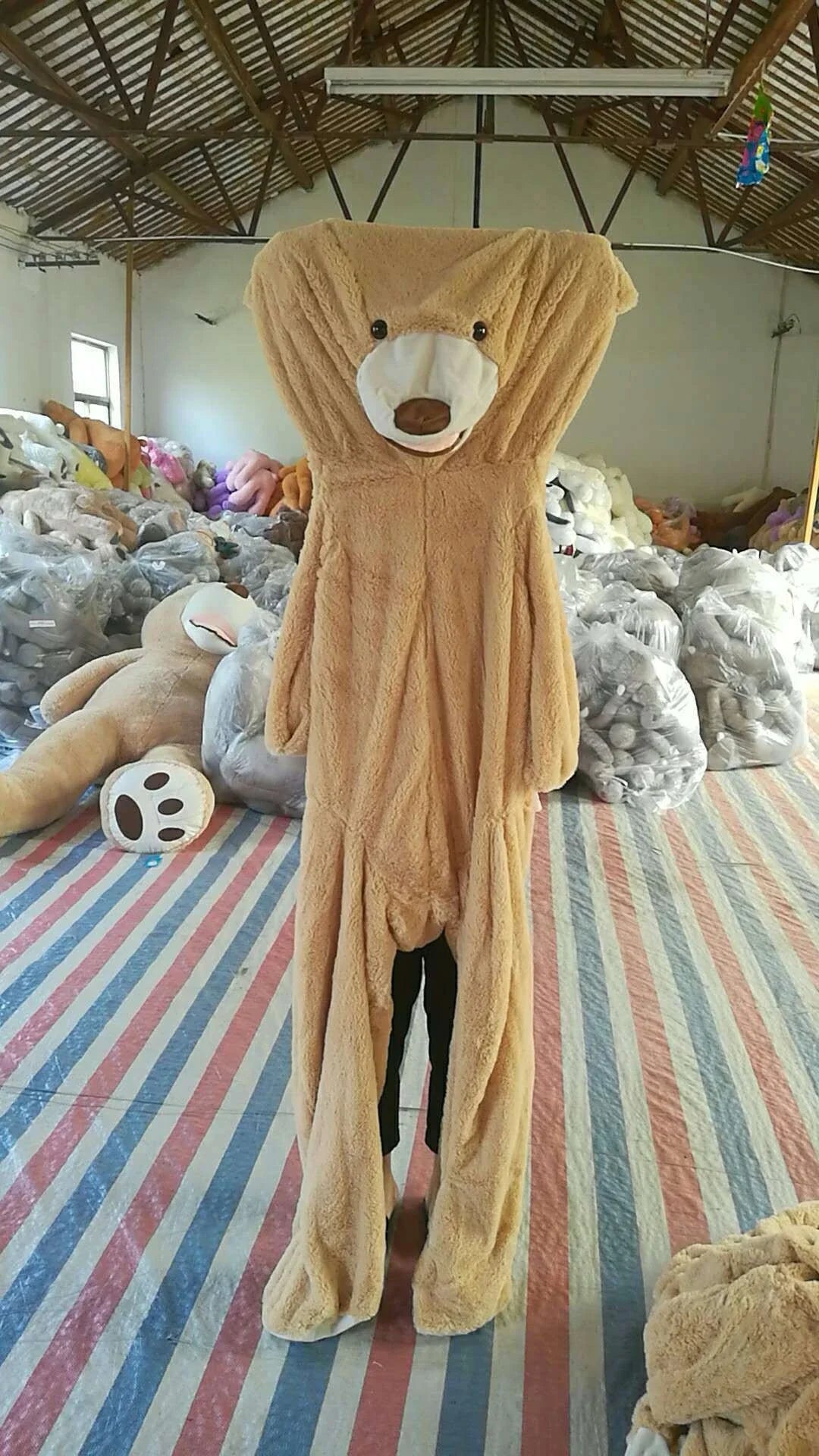 Colossal plush teddy bear in various sizes and colors, featuring a premium leather exterior and soft, cuddly interior