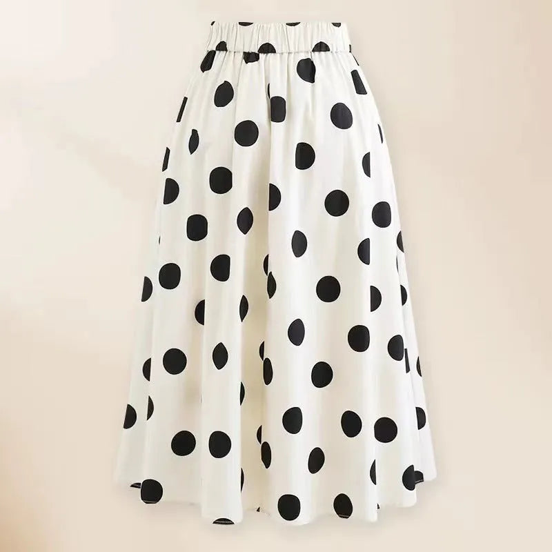 Women's black one-piece swimsuit with white attached round skirt and decorative bow at front