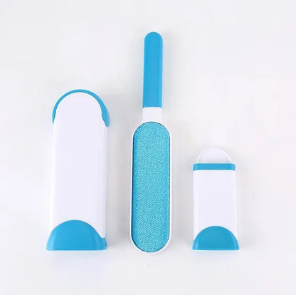 Blue reusable pet hair removal brush with double-sided head next to its self-cleaning base.