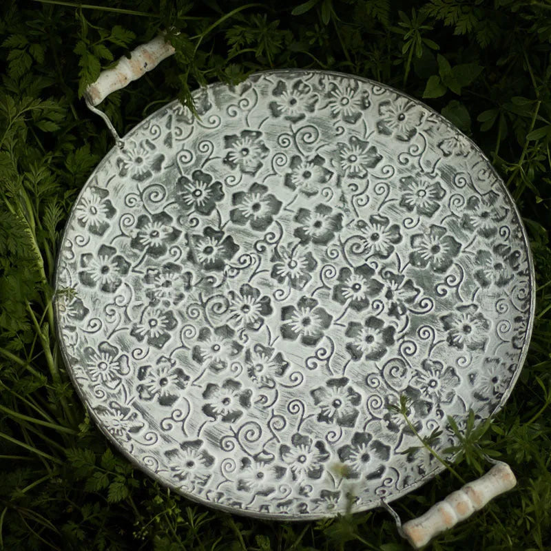 Round wrought iron storage tray in two sizes for organising jewellery or household items.
