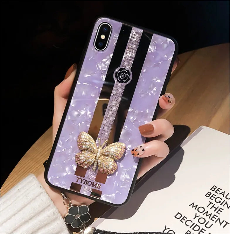 Decorative acrylic iPhone case featuring a diamond butterfly design with a mirror, shown in rose colour.