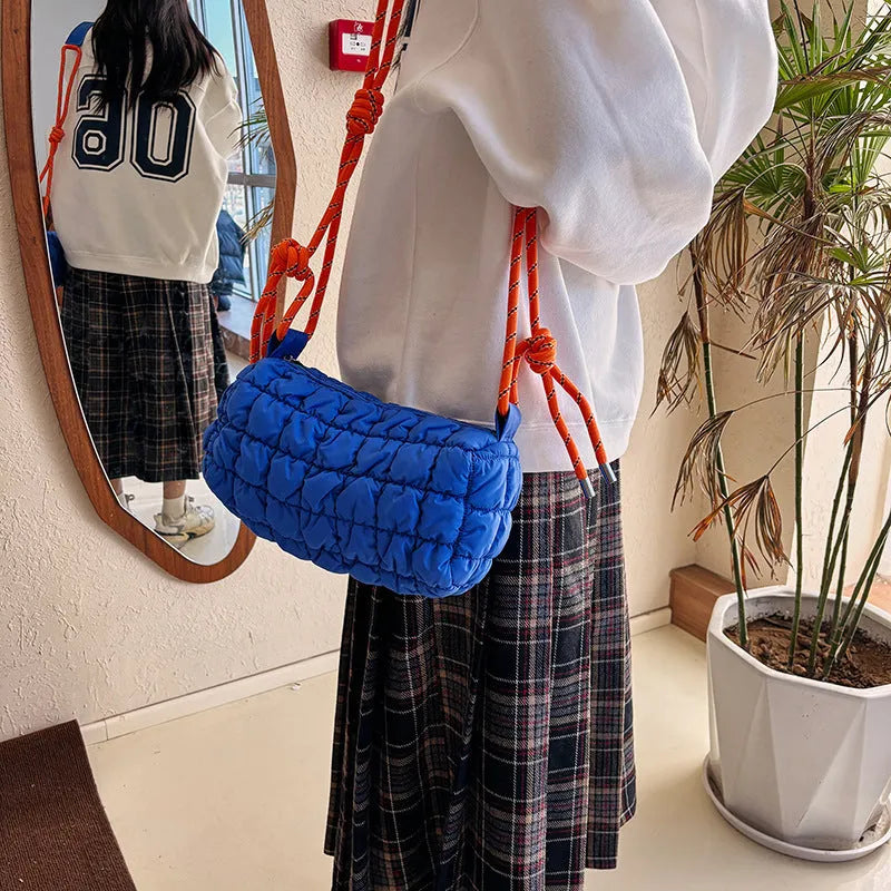 Women's lightweight nylon messenger bag in pillow shape with single shoulder strap, available in black, blue, brown, khaki, rose red and white colours, featuring a zippered change compartment and rhombus pattern detailing