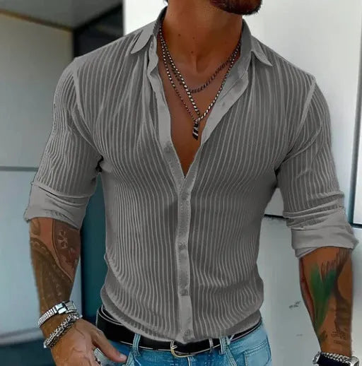 Man wearing a loose fit plain colour striped long sleeve cardigan shirt.