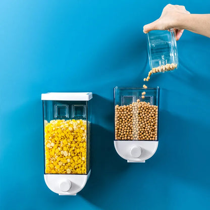 White wall-mountable kitchen food storage box with press lid dispenser, showing transparent body with cereal inside.