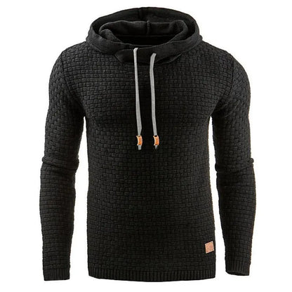 A man wearing a cotton-polyester blend hoodie available in nine colours including black, navy, and red.
