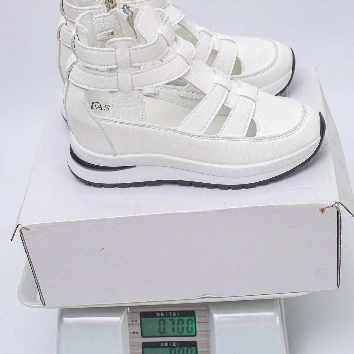 Black women's close-toed platform sandals with hollow-out design and Velcro strap.