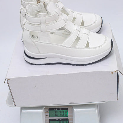 Black women's close-toed platform sandals with hollow-out design and Velcro strap.
