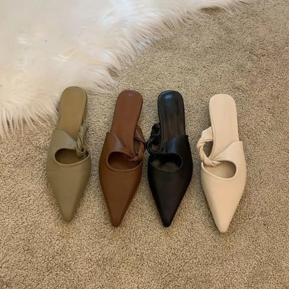 Women's soft leather-lined semi-toe box slippers in neutral colours on a rubber sole.