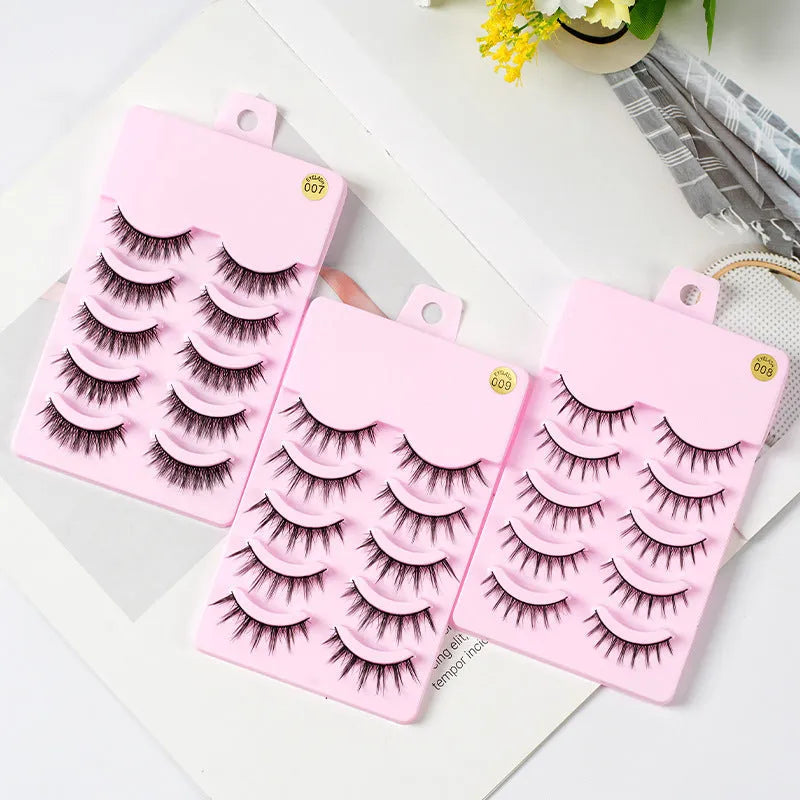 Three styles of black anime false eyelashes on a white background from a 15-pair pack.