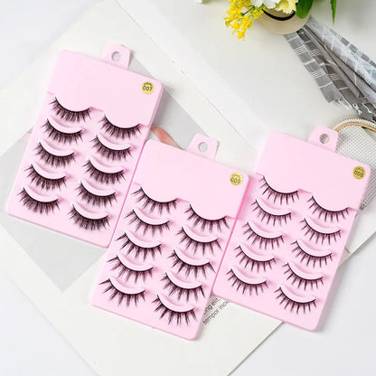 Three styles of black anime false eyelashes on a white background from a 15-pair pack.