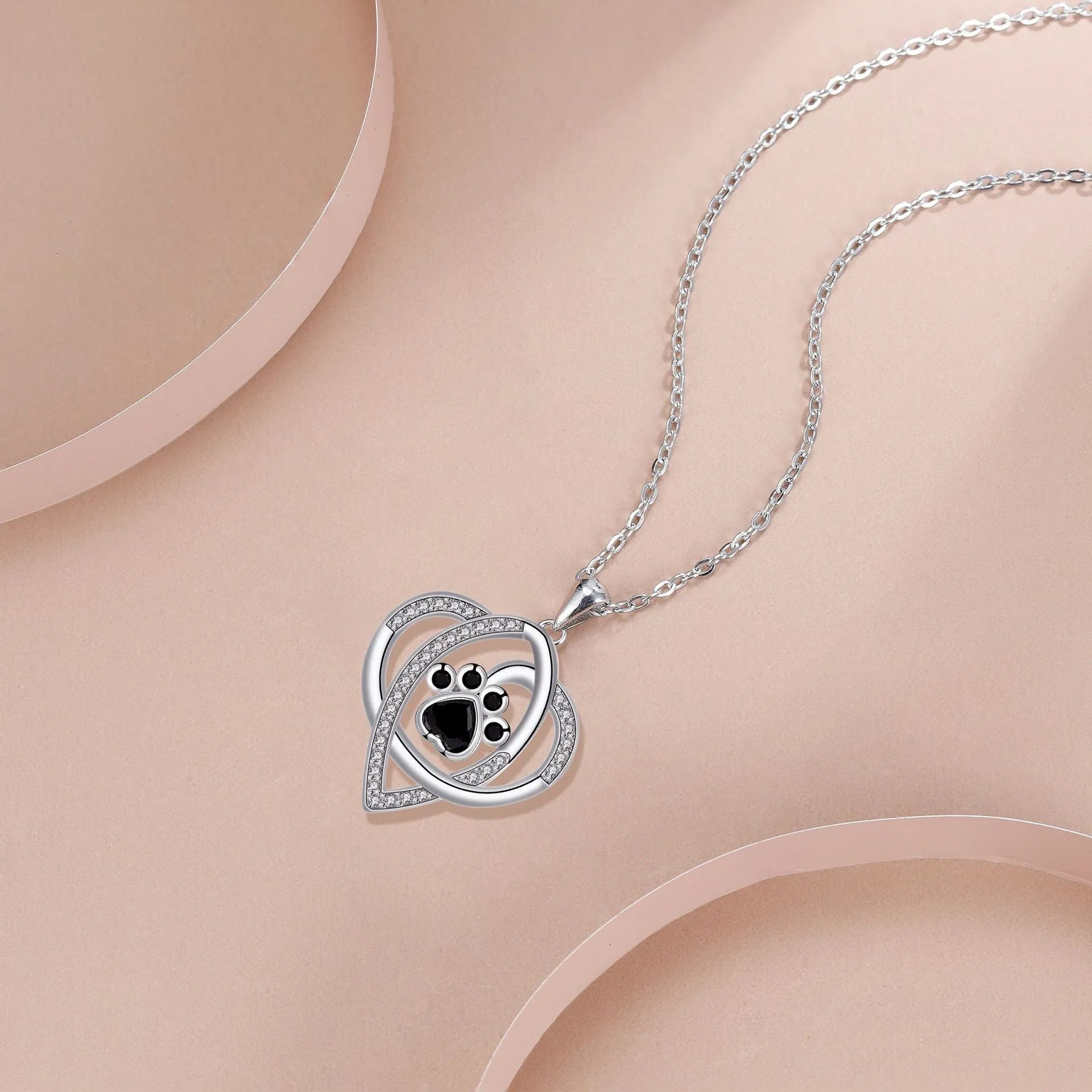 Women's necklace with dog and cat paw print designs on electroplated copper pendant