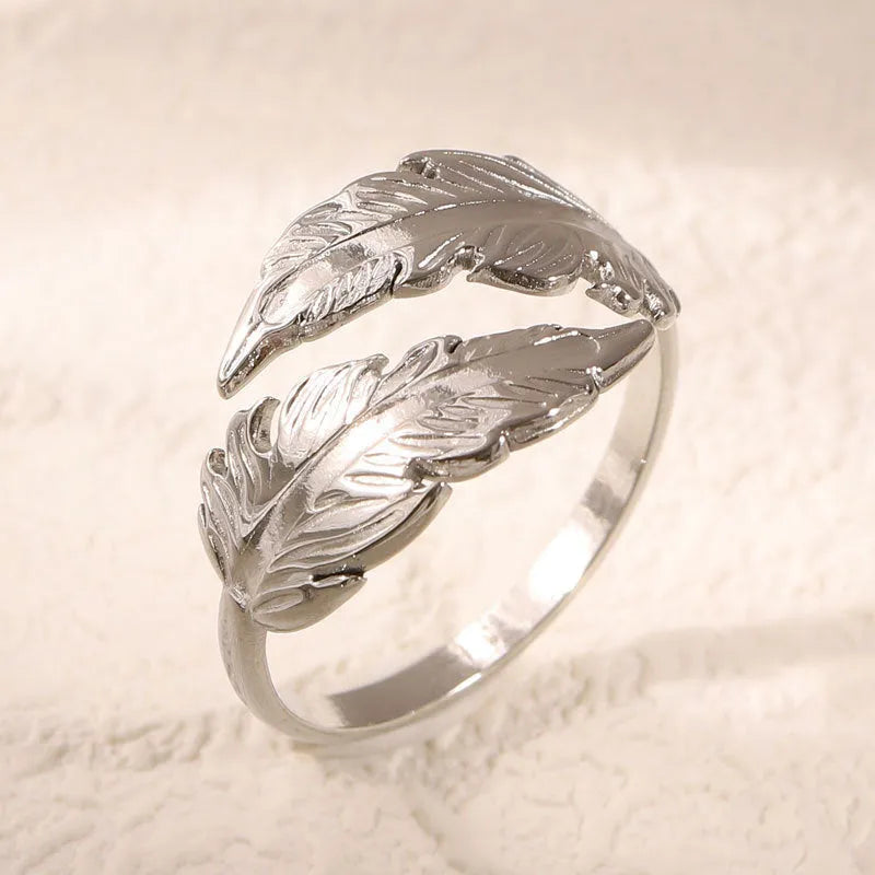 Women's stainless steel feather fashion ring with adjustable opening in silver or gold colour