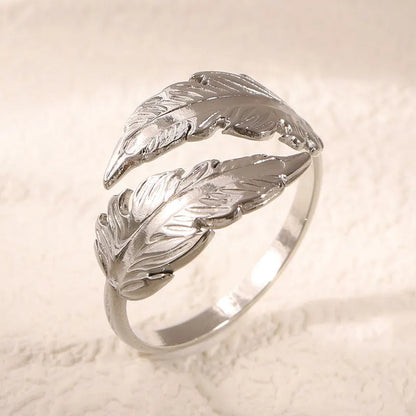 Women's stainless steel feather fashion ring with adjustable opening in silver or gold colour