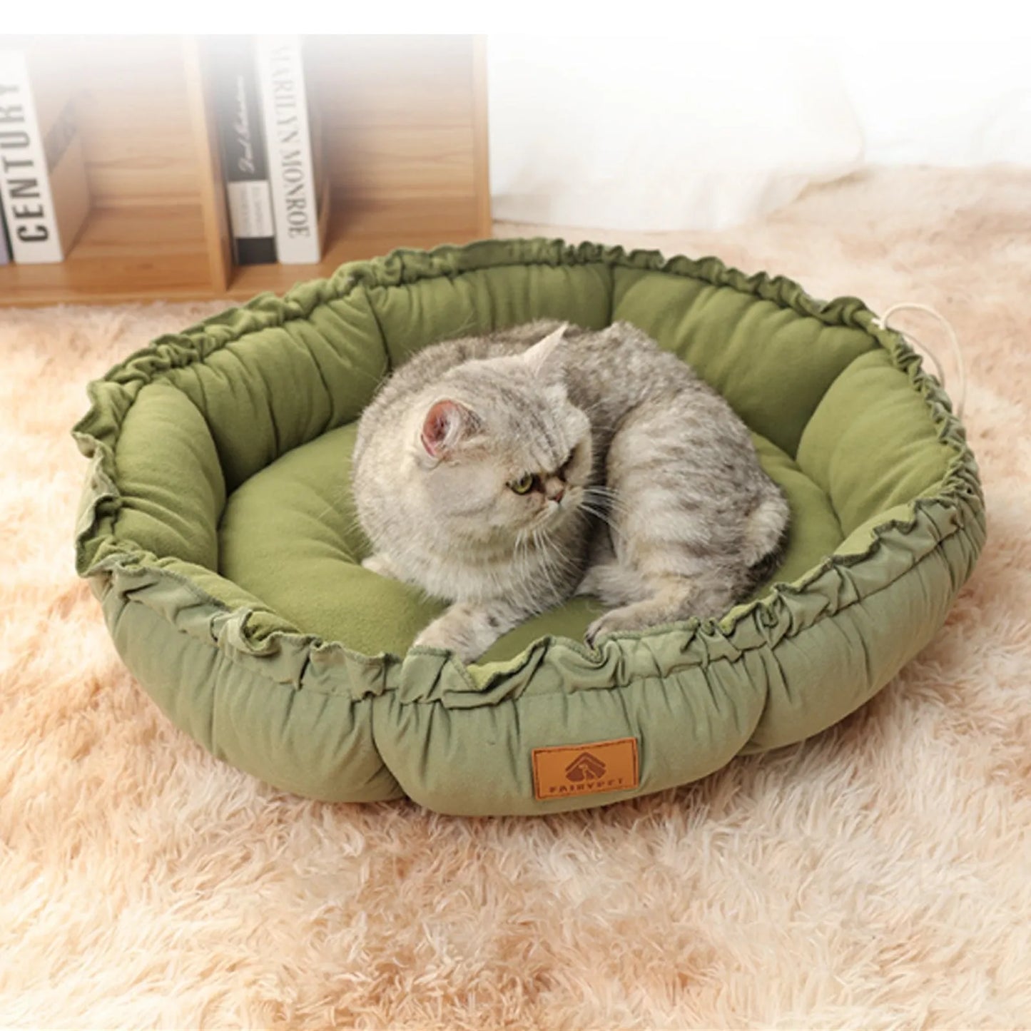 Reversible circular donut cat bed in grey and green colours showing raised outer rim