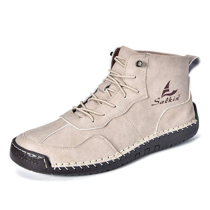 A pair of beige high-top casual boots with elastic band fastening and a flat rubber sole.