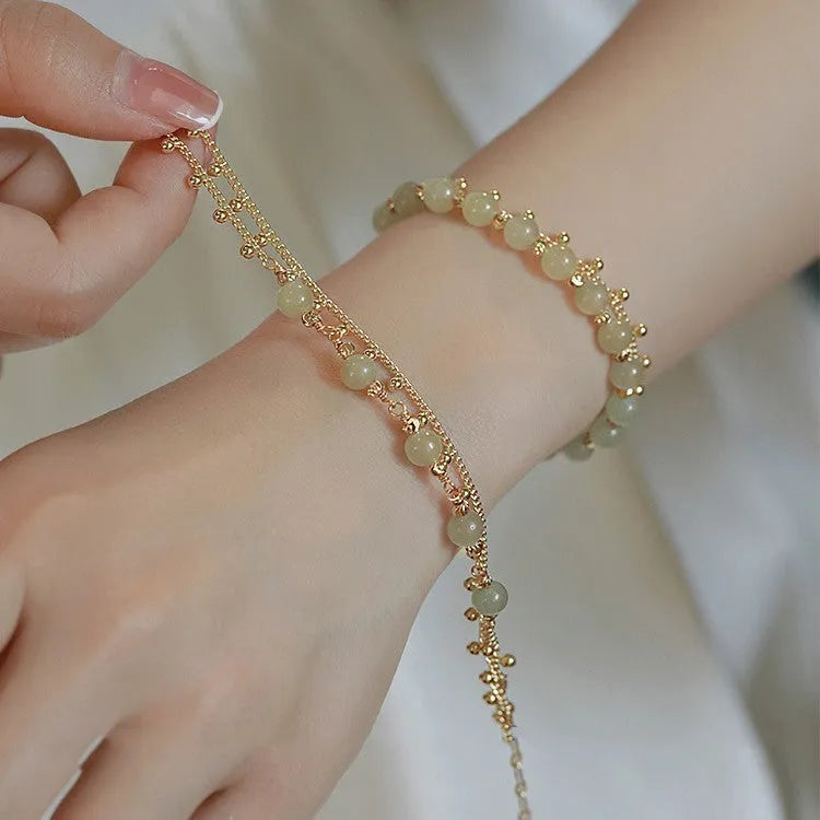 Handmade natural Hetian Jade women's bracelet in a classic beaded style.