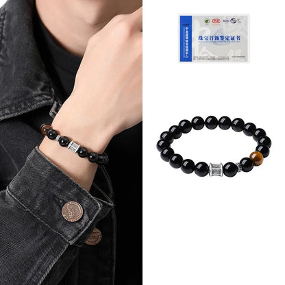 Men's black obsidian bracelet with 10mm prayer wheel beads and silver accents showing hand-woven construction
