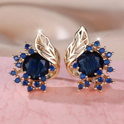Rose gold plated women's stud earrings with a round flower shape, feather detail, and a central cubic zirconia stone.