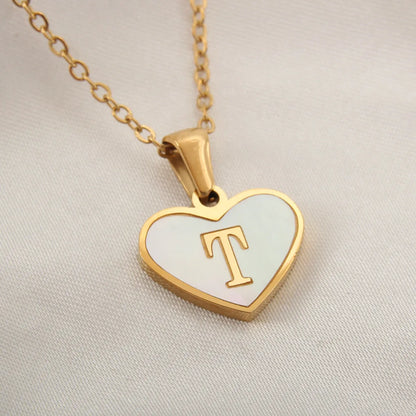 Gold-plated heart necklace with white shell pendant showing letter personalisation option