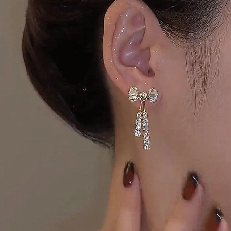 Elegant gold bow diamond crystal earrings for women, perfect for adding a touch of glamour to any outfit.