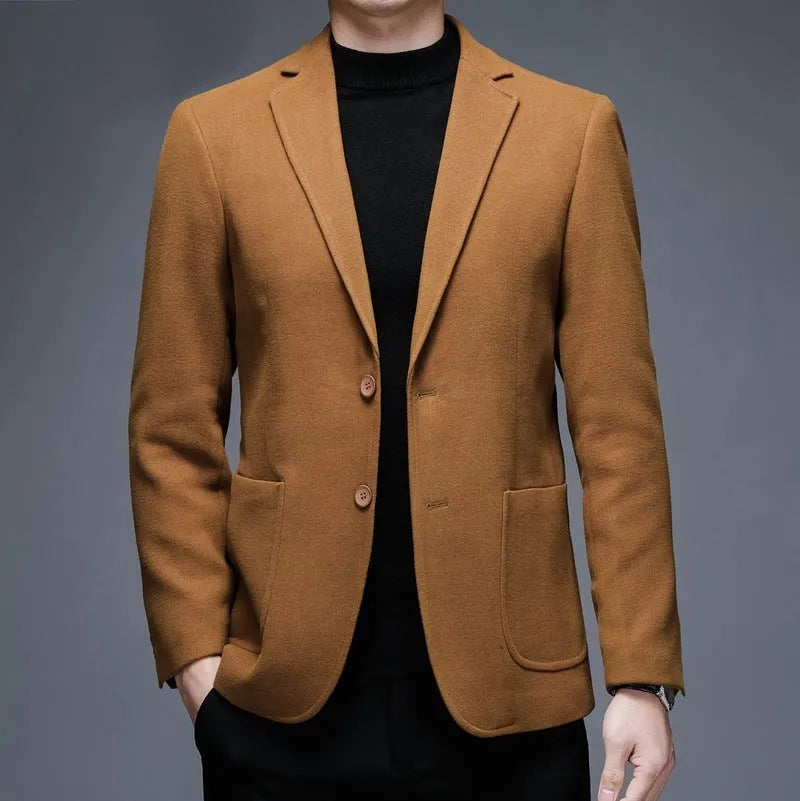 Man wearing a solid colour loose-fit suit-style winter jacket.