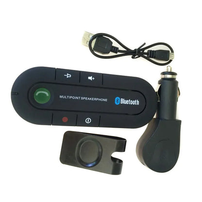 Black Bluetooth hands-free car kit mounted on a car sun visor with charger and cable.