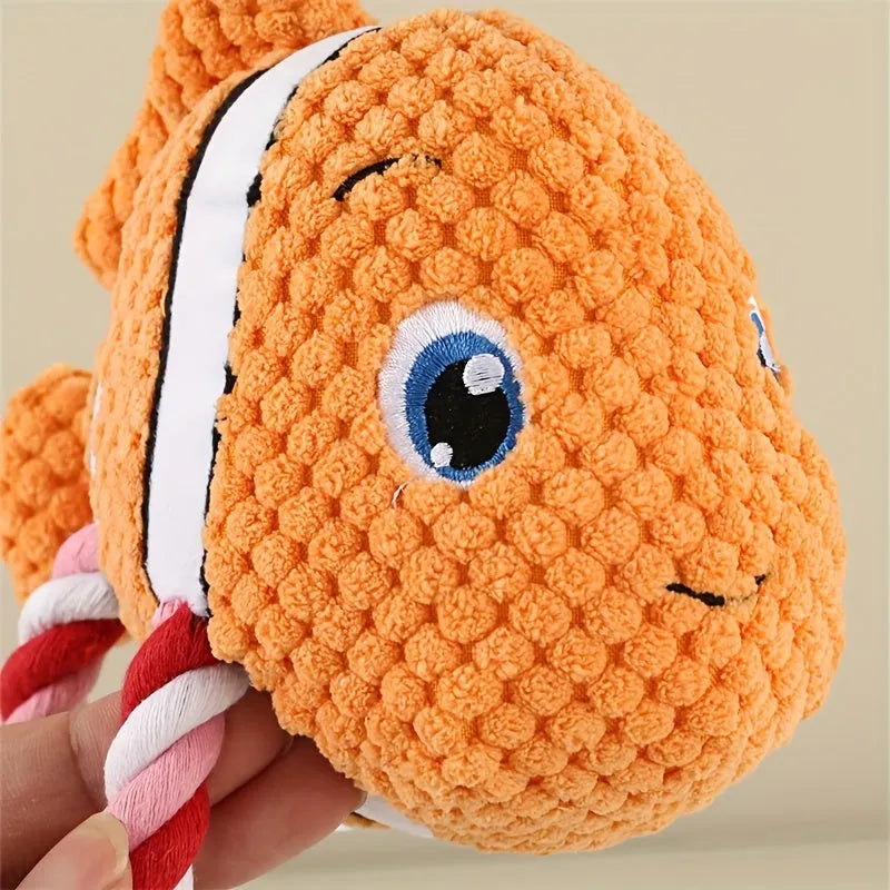Grey turtle-shaped plush dog toy with a knotted rope chew core visible.