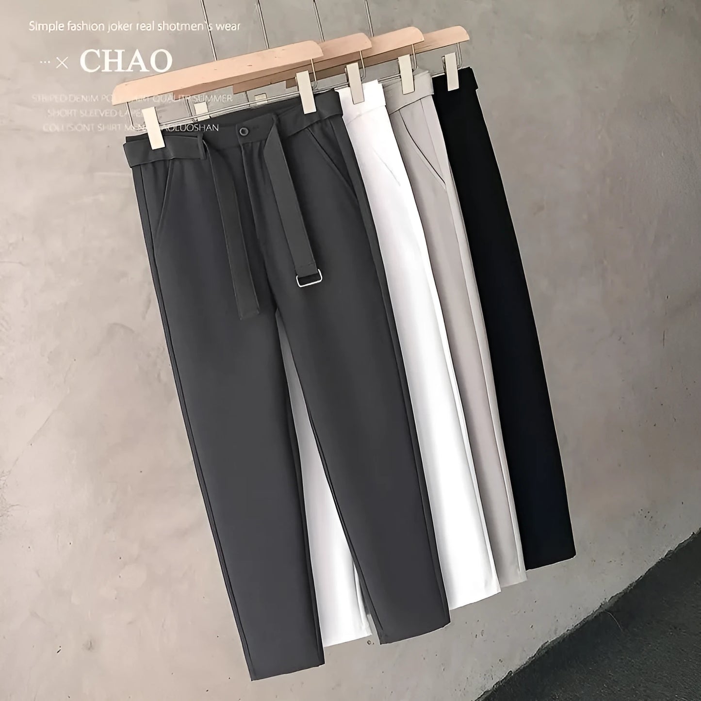 Boys slim straight wool trousers in tapered fit on hanger, showing straight leg opening.