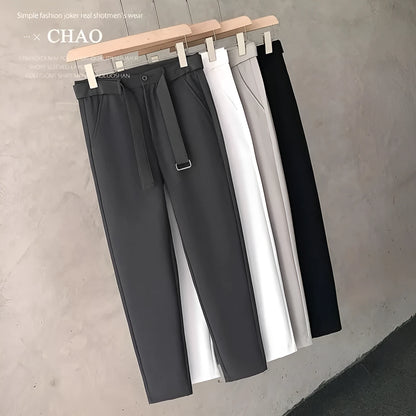 Boys slim straight wool trousers in tapered fit on hanger, showing straight leg opening.