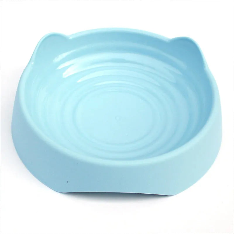 Blue ceramic dog slow feeder bowl with raised internal maze pattern for large breed dogs on a wooden floor.
