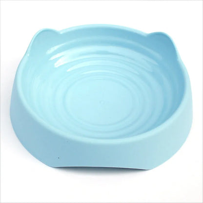 Blue ceramic dog slow feeder bowl with raised internal maze pattern for large breed dogs on a wooden floor.