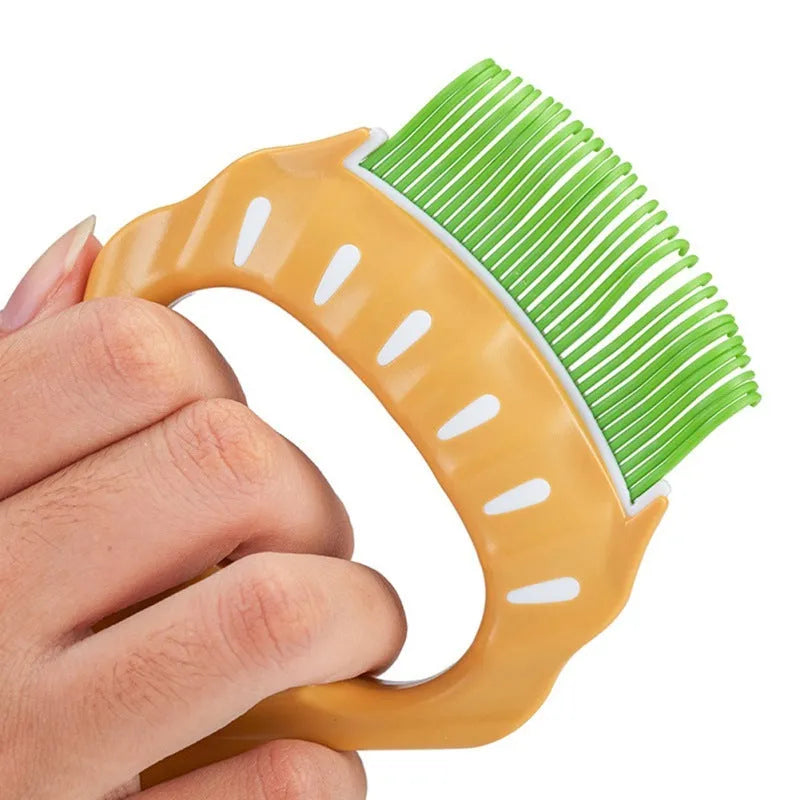 Green shell shaped pet grooming comb with bent wire bristles for removing loose hairs from dogs and cats