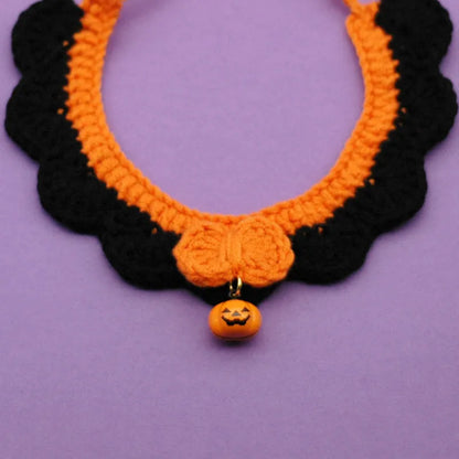 Hand-crocheted wool pet collar in pumpkin colour for a dog or cat, showing adjustable size and textured yarn.