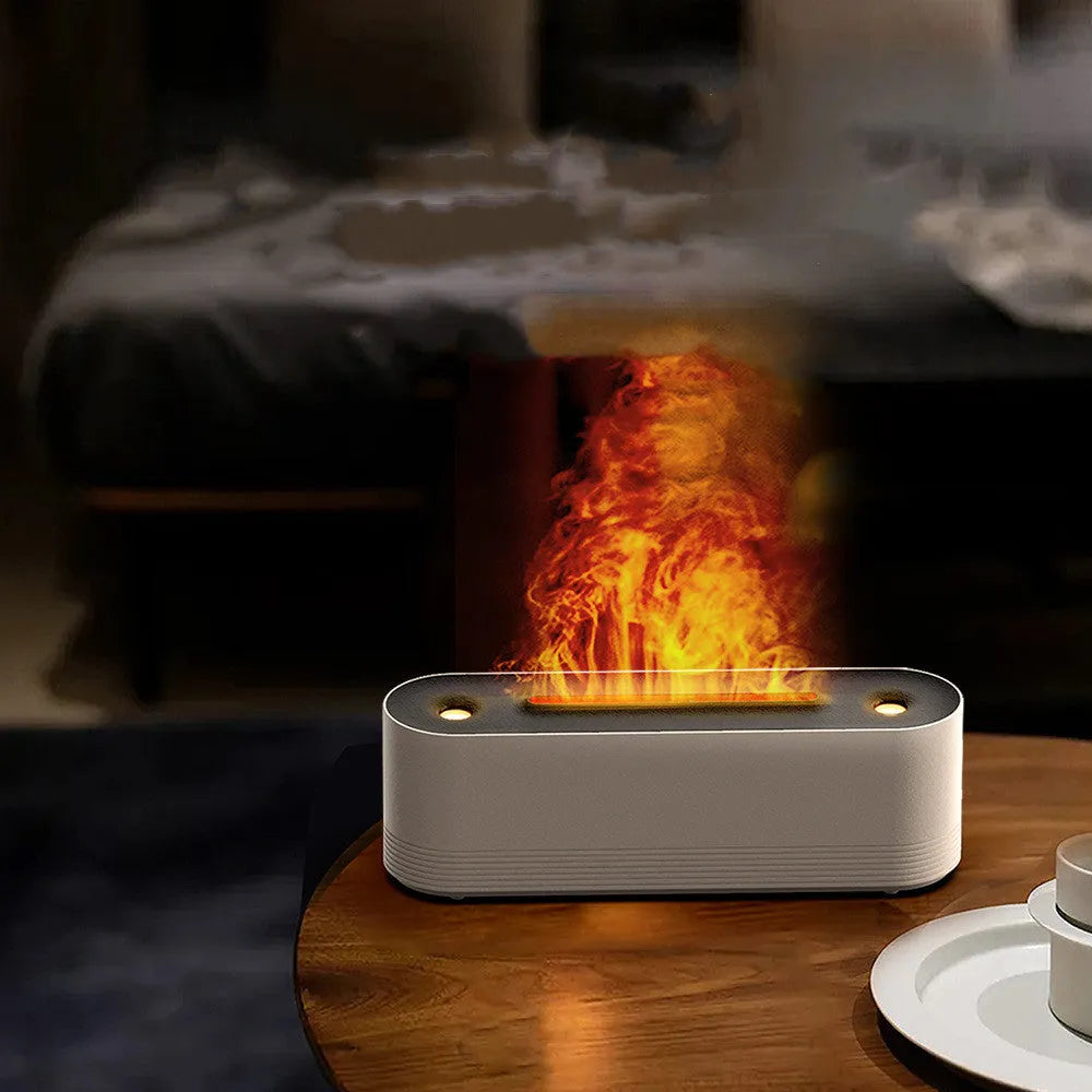 Black ultrasonic humidifier diffuser emitting cool mist with multi-colour LED flame light effect on a wooden surface.