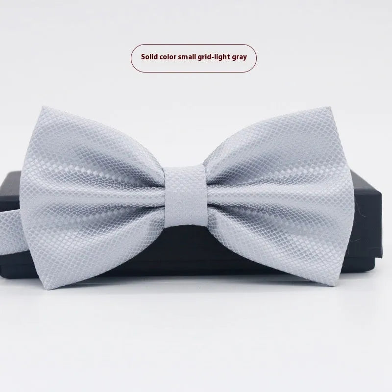 A solid colour pre-tied bow tie with an adjustable neck strap, shown in a classic flat head shape.