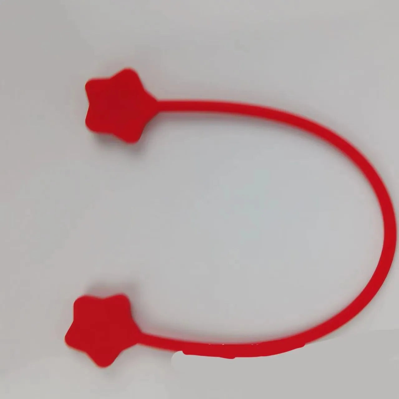 Silicone magnet wire winder for cable organisation in assorted colours on a white background.