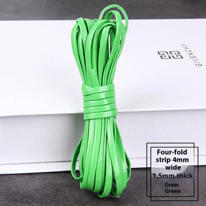 Coiled reels of PU leather craft string in multiple colours including beige, black, red, and blue.
