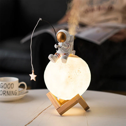 A modern, space-themed humidifier and nightlight figurine made of resin and wood, designed to add a touch of celestial elegance to UK homes.