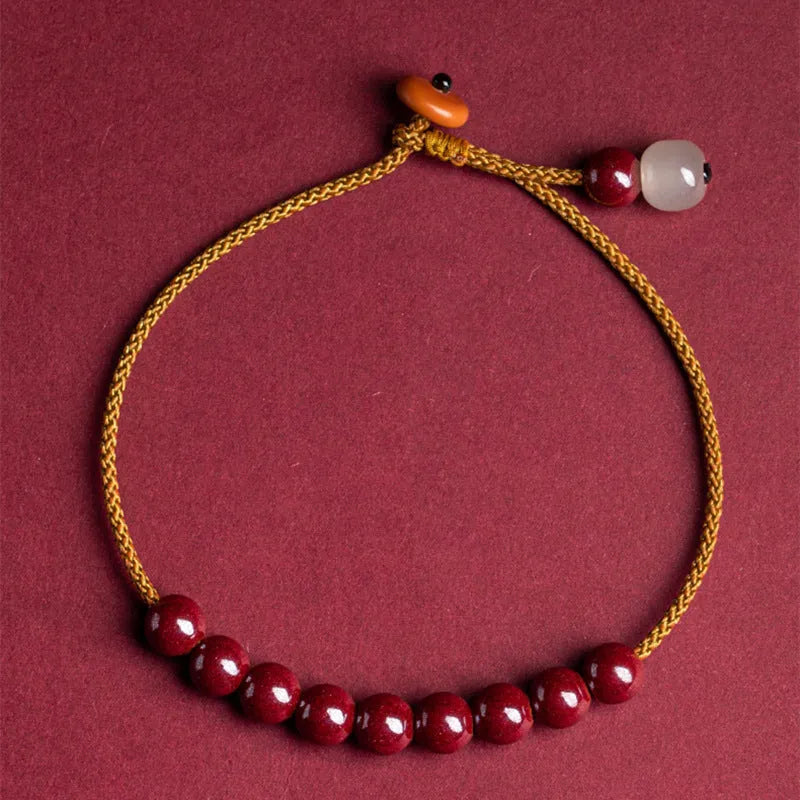 Hand-woven cinnabar bracelet with Hetian jade accents and simple geometric design