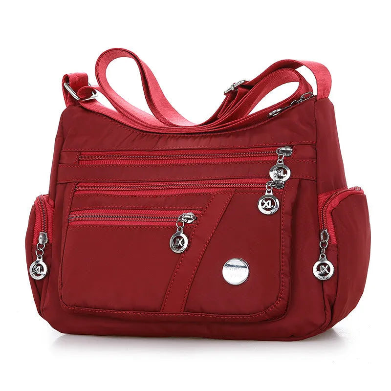 Women's nylon shoulder bag with multi-pocket design, zip opening and detachable handle in red, purple, black or army green