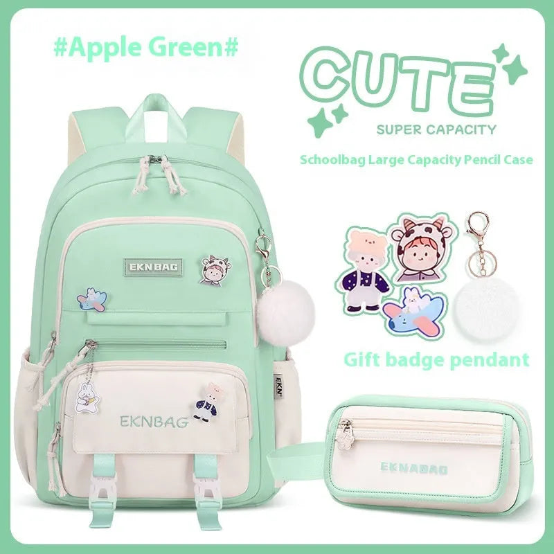 Pink waterproof school backpack for girls with curved ergonomic shoulder straps, shown with matching pencil case.