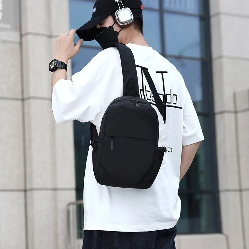 Men's waterproof messenger bag in grey showing front pocket and adjustable shoulder strap