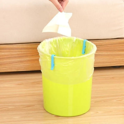 A white polypropylene plastic clip for holding a rubbish bag onto the rim of a bin.