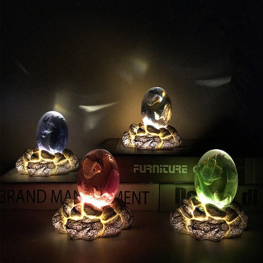 A lifelike resin dragon egg ornament with a crystal-clear, transparent design, sitting on a glowing lava-style base.